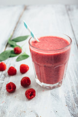 healthy raspberry smoothie on white wooden board