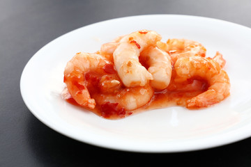 Portion of shrimps with chili sauce on plate