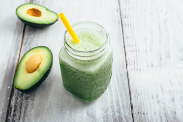 tasty apple smoothie in jar on white wooden table