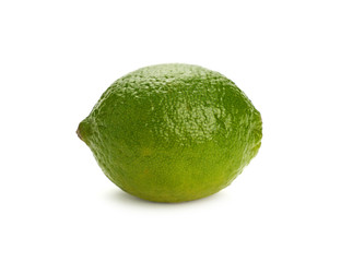 Close up one whole green lime isolated on white