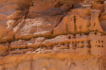 Background based on red sandstone texture. Photos of the walls of the canyon in the Sinai desert