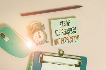 Conceptual hand writing showing Strive For Progress Not Perfection. Concept meaning Improve with flexibility Advance Grow Alarm clock notepad clipboard paper markers color background