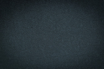 Close-up of black gray plastic material seamless texture. Surface of rough abstract dark black...