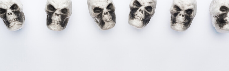 top view of decorative skulls on white background with copy space, panoramic shot