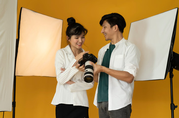 Photographer working with model in studio with equipment