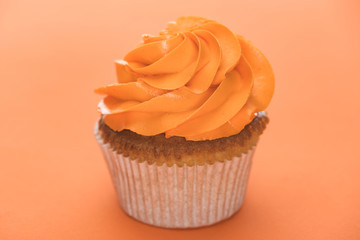 Obraz na płótnie Canvas delicious Halloween cupcake on orange background