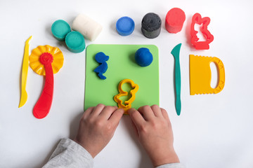 Educational game with clay. Child sculpting figures from clay.