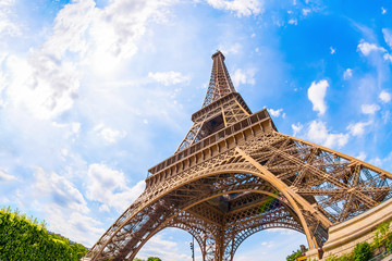 The Eiffel Tower in Paris on a beautiful summer day with blue sky in the background