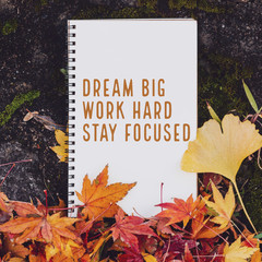 Inspirational and motivation quote notebook with maple leaf in autumn background with vintage...