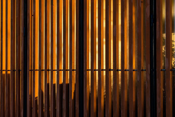Wooden slats on building facade with first morning light