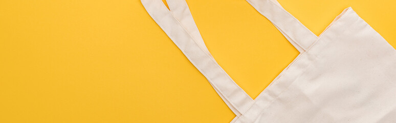 top view of cotton eco friendly bag isolated on yellow, panoramic shot
