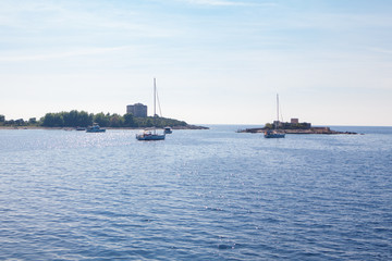 Naklejka premium yachts sailing near Mamula island in Adriatic Sea 
