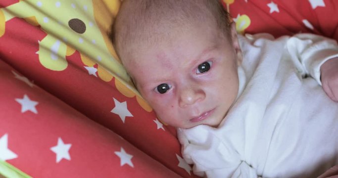 Baby boy in a rocking cradle