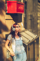 Fototapeta premium Young girl in headphones in New York City
