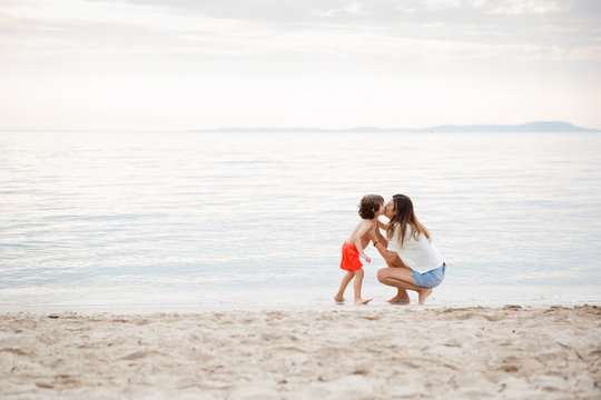 Mother and son kissing each other at beach