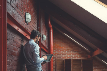 Working young businessman in the loft