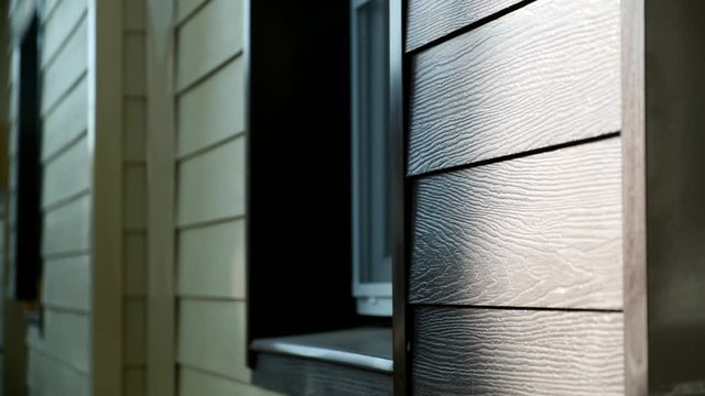 Decoration of houses with siding. Stock footage. Wooden facing of facade of house. Beautiful facade decoration of house made under wooden texture