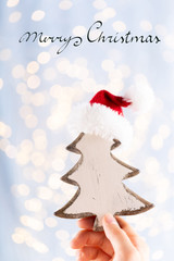 Christmas decor in women hand. Christmas greeting card. Woman's hands hold christmas or new year decorated gift.