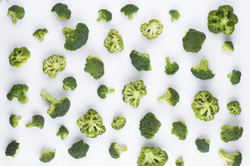 Broccoli pattern isolated on a white background. Various multiple parts of broccoli flower. Top view.