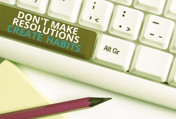 Writing note showing Don T Make Resolutions Create Habits. Business concept for Routine for everyday to achieve goals White pc keyboard with note paper above the white background