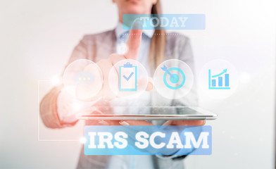 Text sign showing Irs Scam. Business photo text targeted taxpayers by pretending to be Internal Revenue Service Female human wear formal work suit presenting presentation use smart device