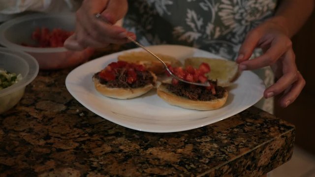 Mexican Food: Female hands cooking Tortas de Barbacoa.