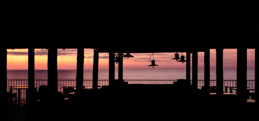 Beautiful sunset (sunrise) on a cafe background with lamps in retro style.