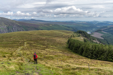 Wicklow way landscape, Glendalough vale, with a girl in the path.