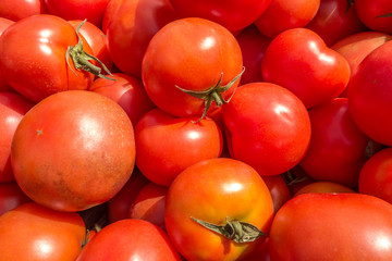 background of fresh juicy tomatoes at the market