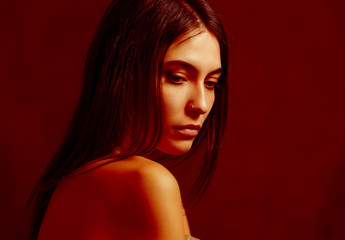 Fototapeta premium Close-up portrait of young woman with golden-red makeup.