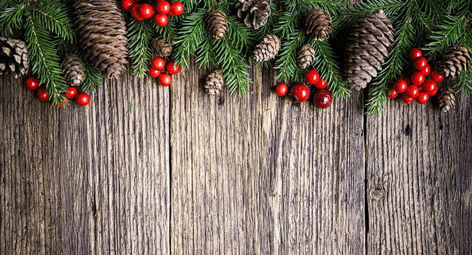 Christmas tree branches on rustic wooden planks background