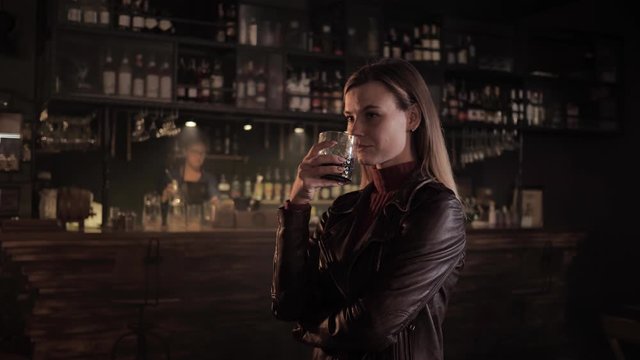catering, beautiful girl tasting cocktail prepared by professional bartender in trendy bar