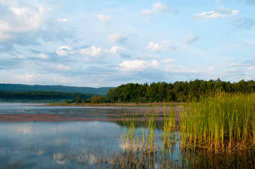 beautiful autumn lake overlooking mountains and blue sky