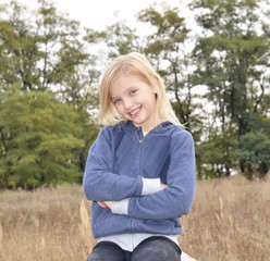 Family holiday. Portrait of a cheerful happy girl with blond hair and blue eyes.