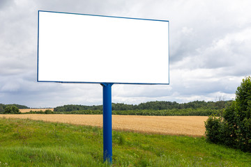 Big blank billboard mock-up along highway against field
