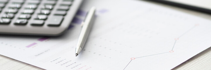 Silver pen lying at paper document