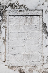 Walled up window of a house with white facade