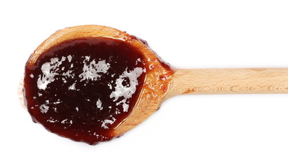 Traditional strawberry jam with wooden spoon isolated on white background, top view