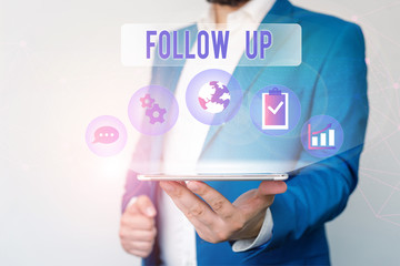 Text sign showing Follow Up. Business photo text Additional info or any activity that needs to check secondly Male human wear formal work suit presenting presentation using smart device