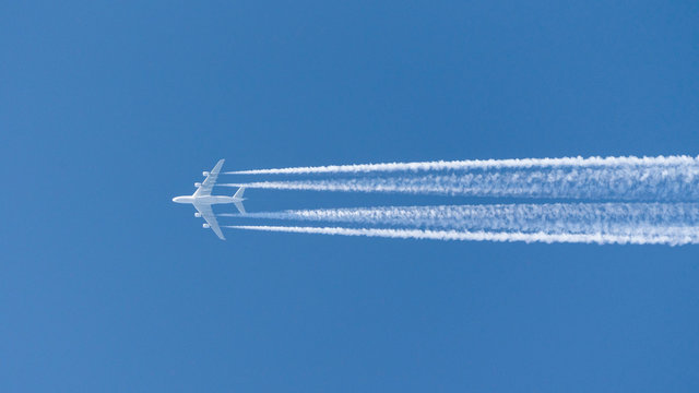 four-engined jet aircraft, jet airbus a380 airplane in the sky with condensation stripes