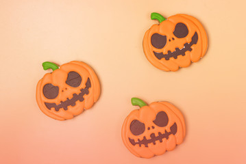 Halloween Homemade Gingerbread Cookies in Shape of Angry Pumpkin Three Halloween Cookies on Yellow Background Toned Horizontal Top View