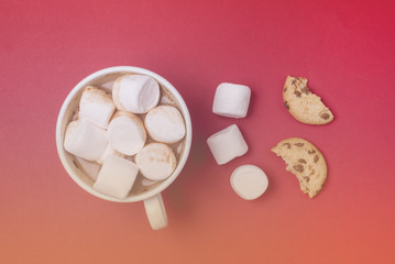 Fototapeta na wymiar White Cup of Cocoa with Marshmallow Broken Cookies and Three Marshmallow on Red Background Festive Christmas Food Backgroundor Concept Flat Lay Top View