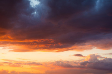 Fototapeta na wymiar Storm clouds at sunset in bright colors