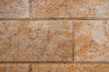Elevated view of orange-yellow granite tile wall