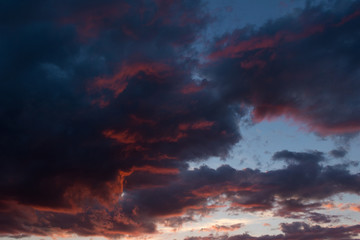 Fototapeta na wymiar Storm clouds at sunset in bright colors