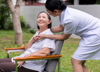 Nurse holding hands to elderly Asian woman with Alzheimer disease,Positive thinking,Happy and...