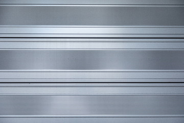 Close-up of shiny metal surface with horizontal stripes