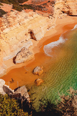 Crystal clear beach in a rock in a rock bay cave at the wild coastline with nature landscape view....