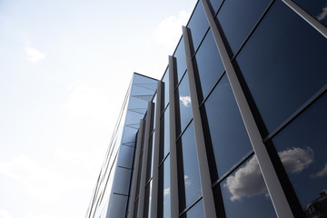 Fototapeta na wymiar bottom view of black glass wall of office building