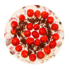 white creamy jelly cake with chocolate crust, decorated with whole strawberries, on a white background